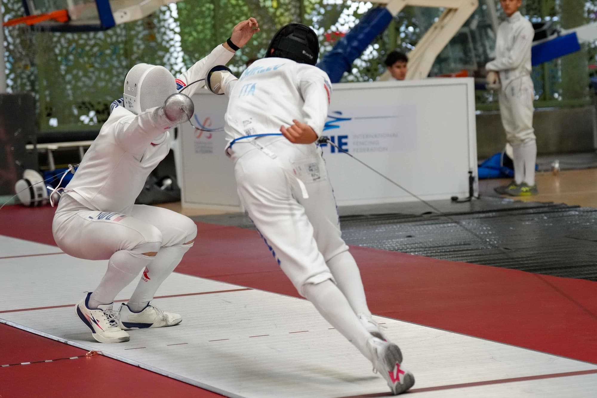 Ari in a bout against an Italian fencer at an international competition